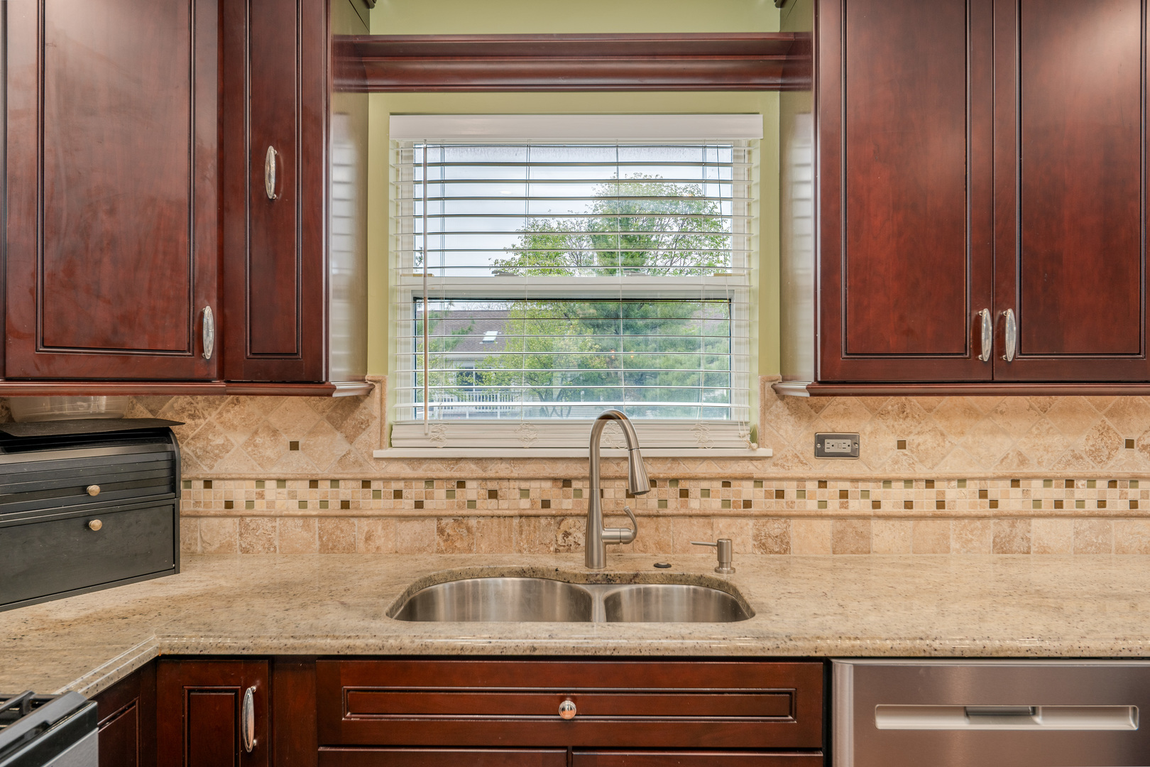 2040 Garfield Avenue Aurora, IL 60506 - Photo 8 of 32 a kitchen with granite countertop a sink and a window