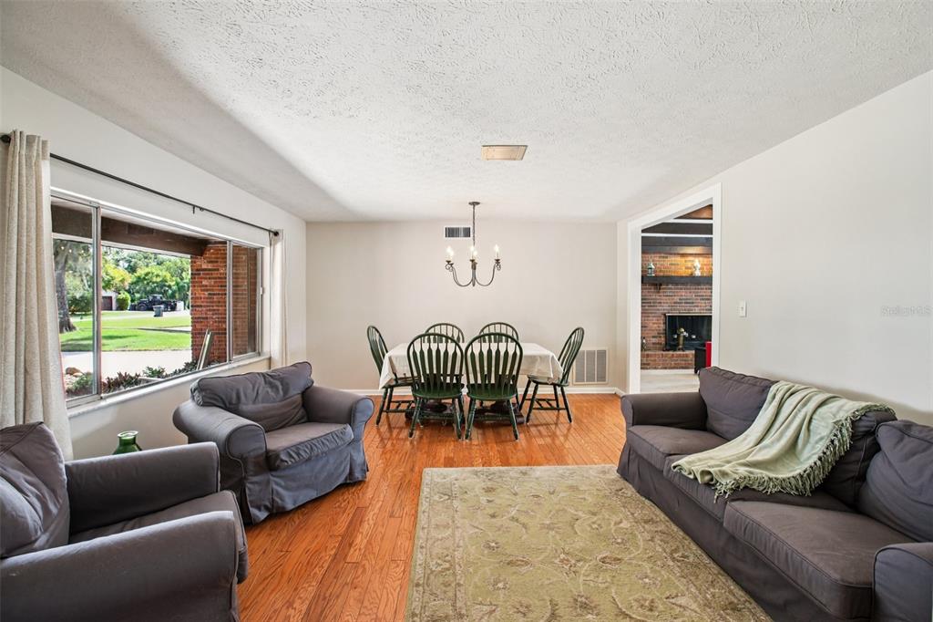 19254 Blount Road Lutz, FL 33558 - Photo 15 of 35 a living room with furniture floor to ceiling window and a table