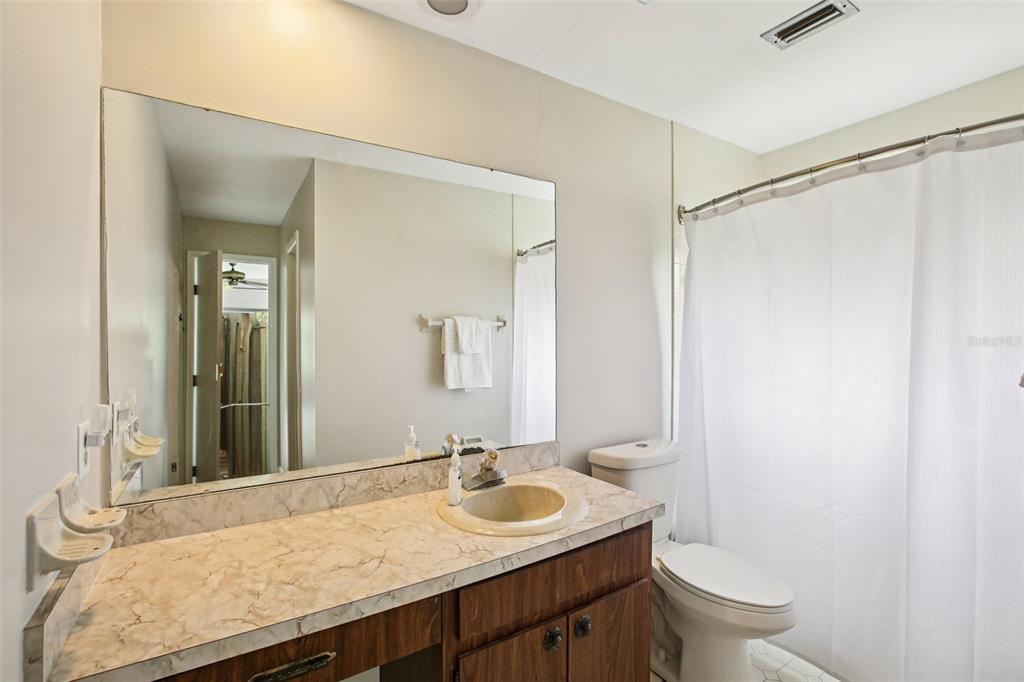 19254 Blount Road Lutz, FL 33558 - Photo 22 of 35 a bathroom with a granite countertop sink and a mirror