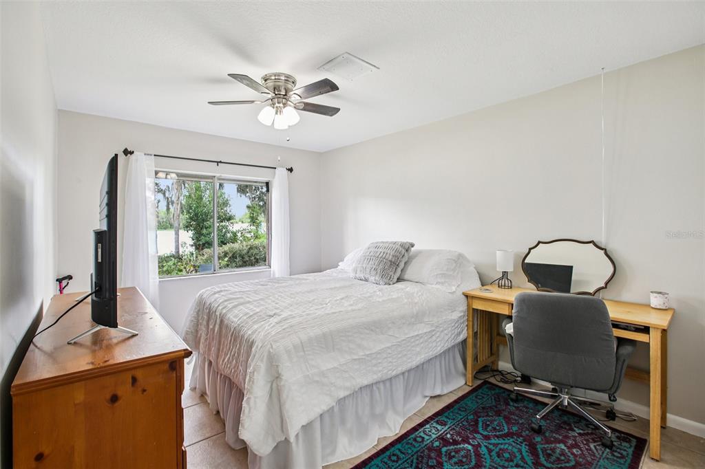 19254 Blount Road Lutz, FL 33558 - Photo 23 of 35 a bedroom with a bed and a desk