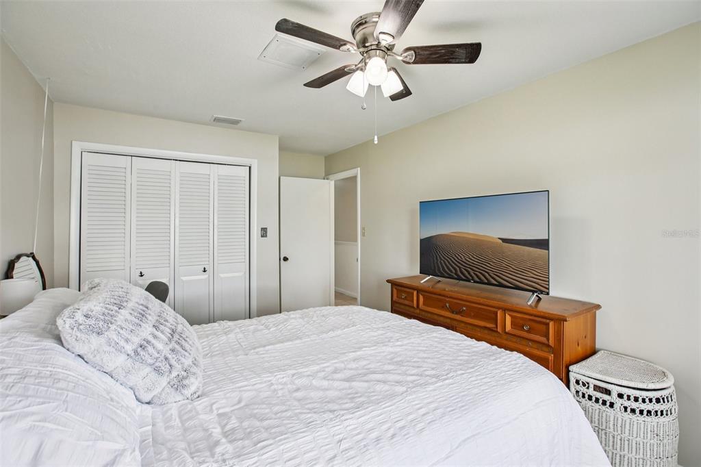 19254 Blount Road Lutz, FL 33558 - Photo 24 of 35 a bedroom with a bed and a flat screen tv