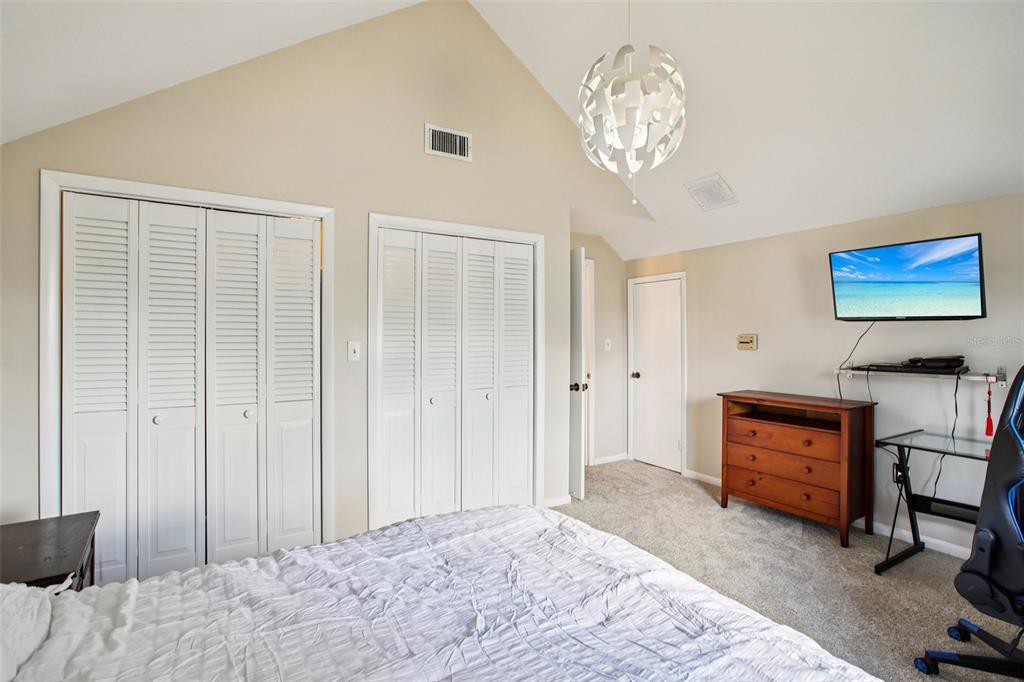 19254 Blount Road Lutz, FL 33558 - Photo 27 of 35 a bedroom with a bed and a chandelier