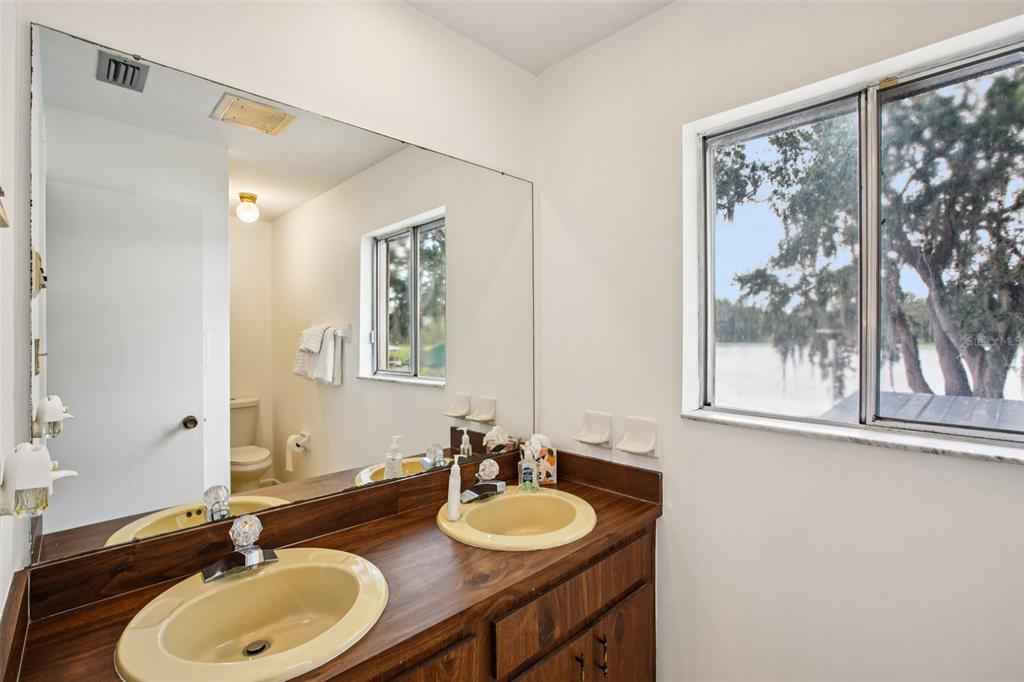 19254 Blount Road Lutz, FL 33558 - Photo 28 of 35 a bathroom with a granite countertop sink and a mirror