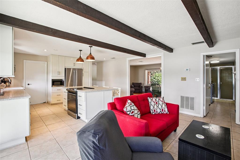 19254 Blount Road Lutz, FL 33558 - Photo 8 of 35 a living room with furniture kitchen view and a refrigerator
