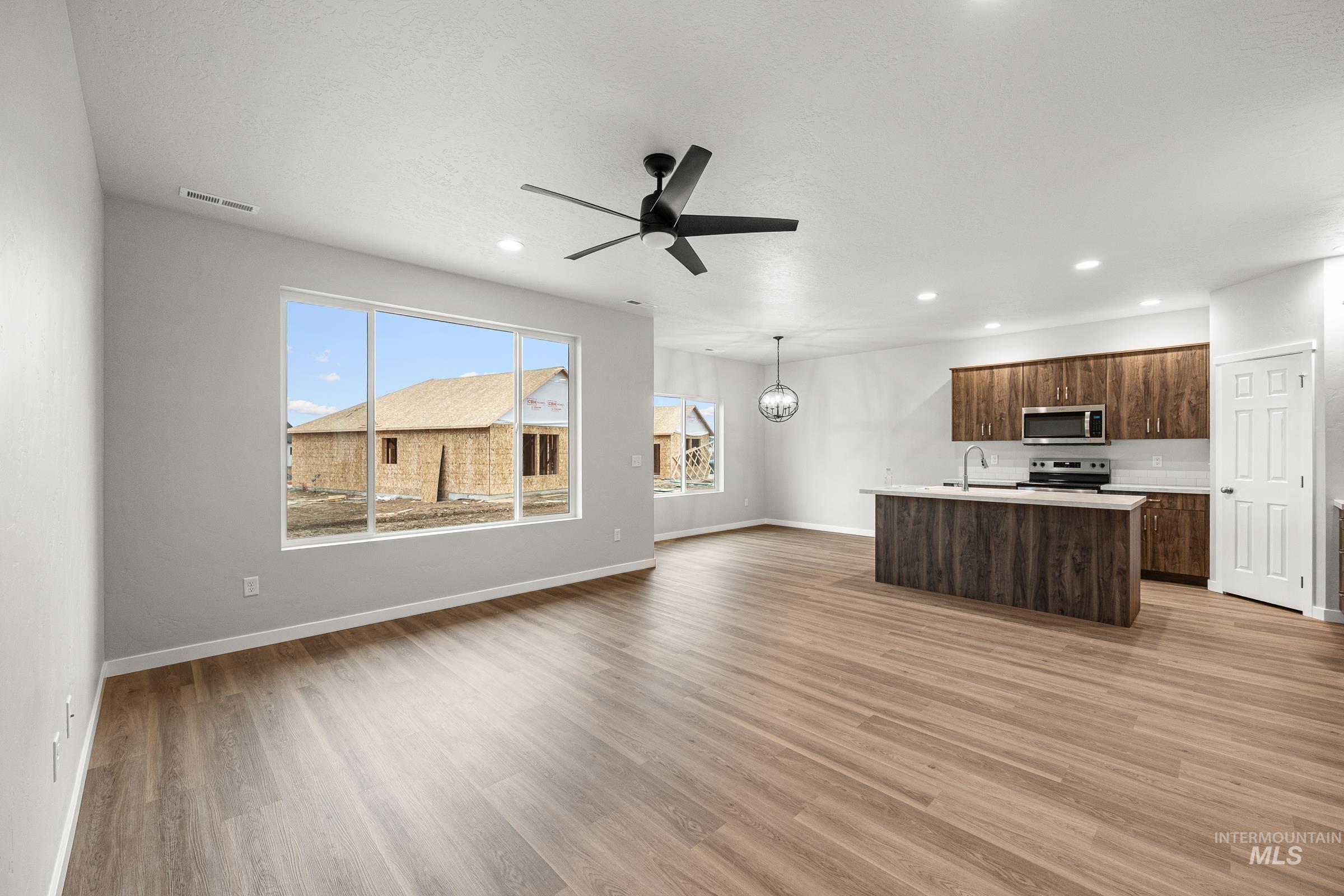13656 Redway Court Caldwell, ID 83607 - Photo 11 of 21 Dedicated laundry space featuring wood-finish flooring, a built-in counter, and upper shelving with a hanging rod