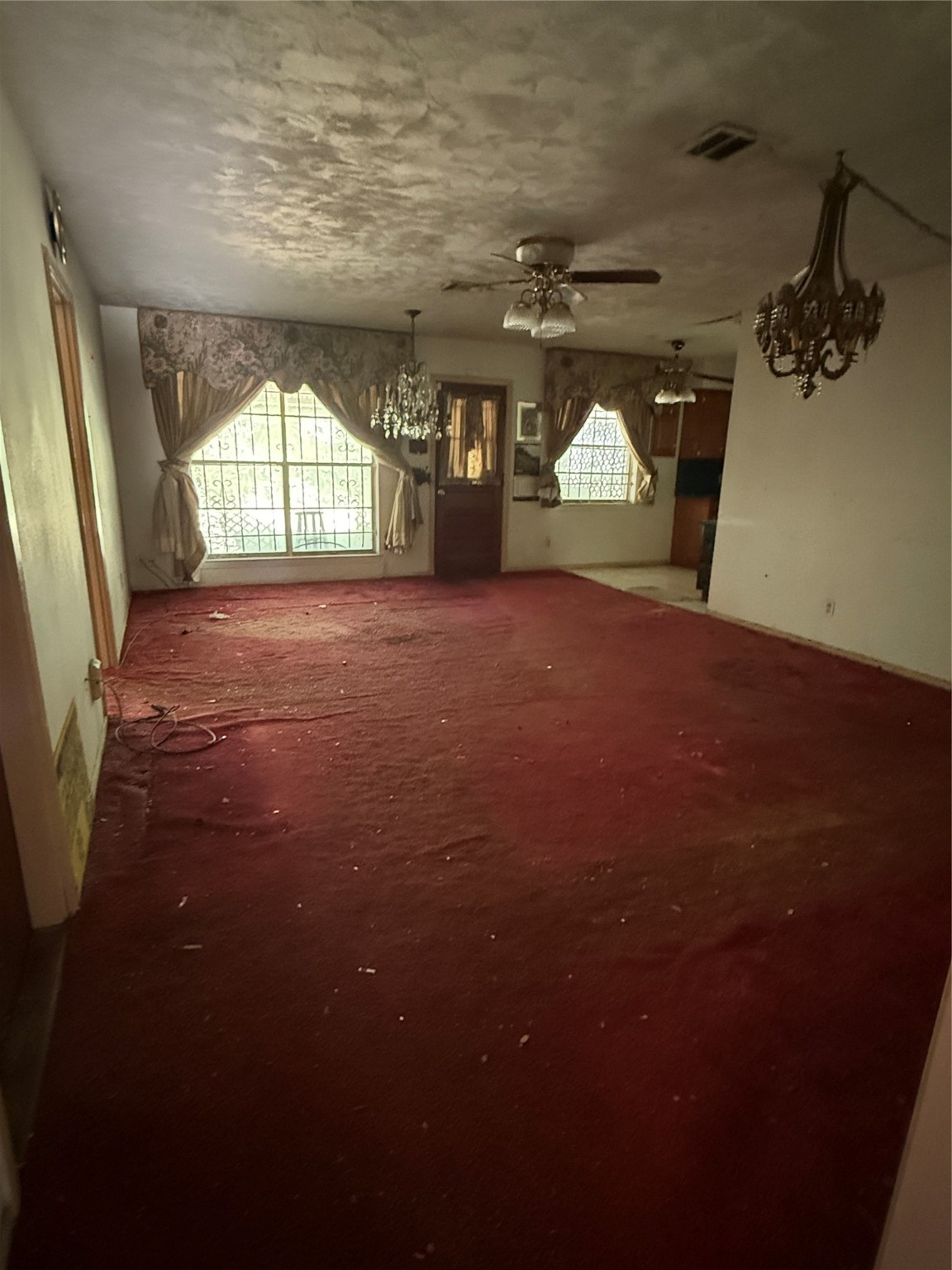 7705 Yoe Street Houston, TX 77016 - Photo 2 of 9 an empty room with wooden floor and windows
