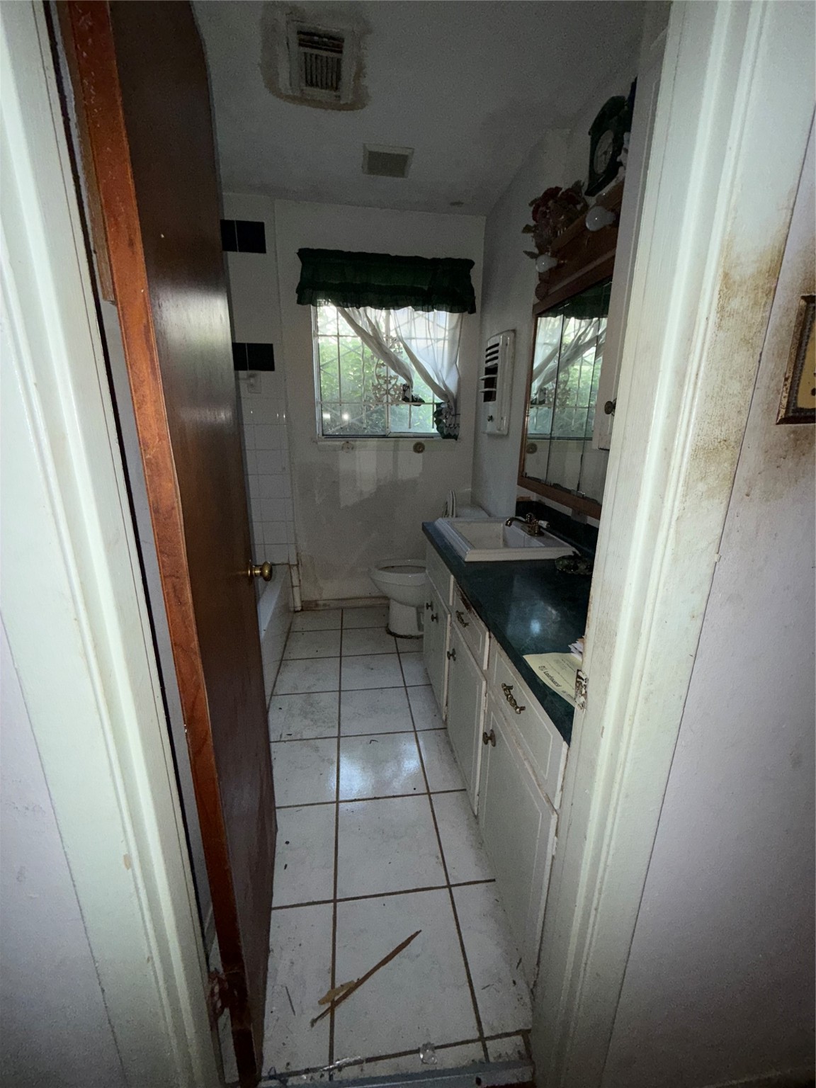 7705 Yoe Street Houston, TX 77016 - Photo 7 of 9 a kitchen with a sink and wooden cabinets