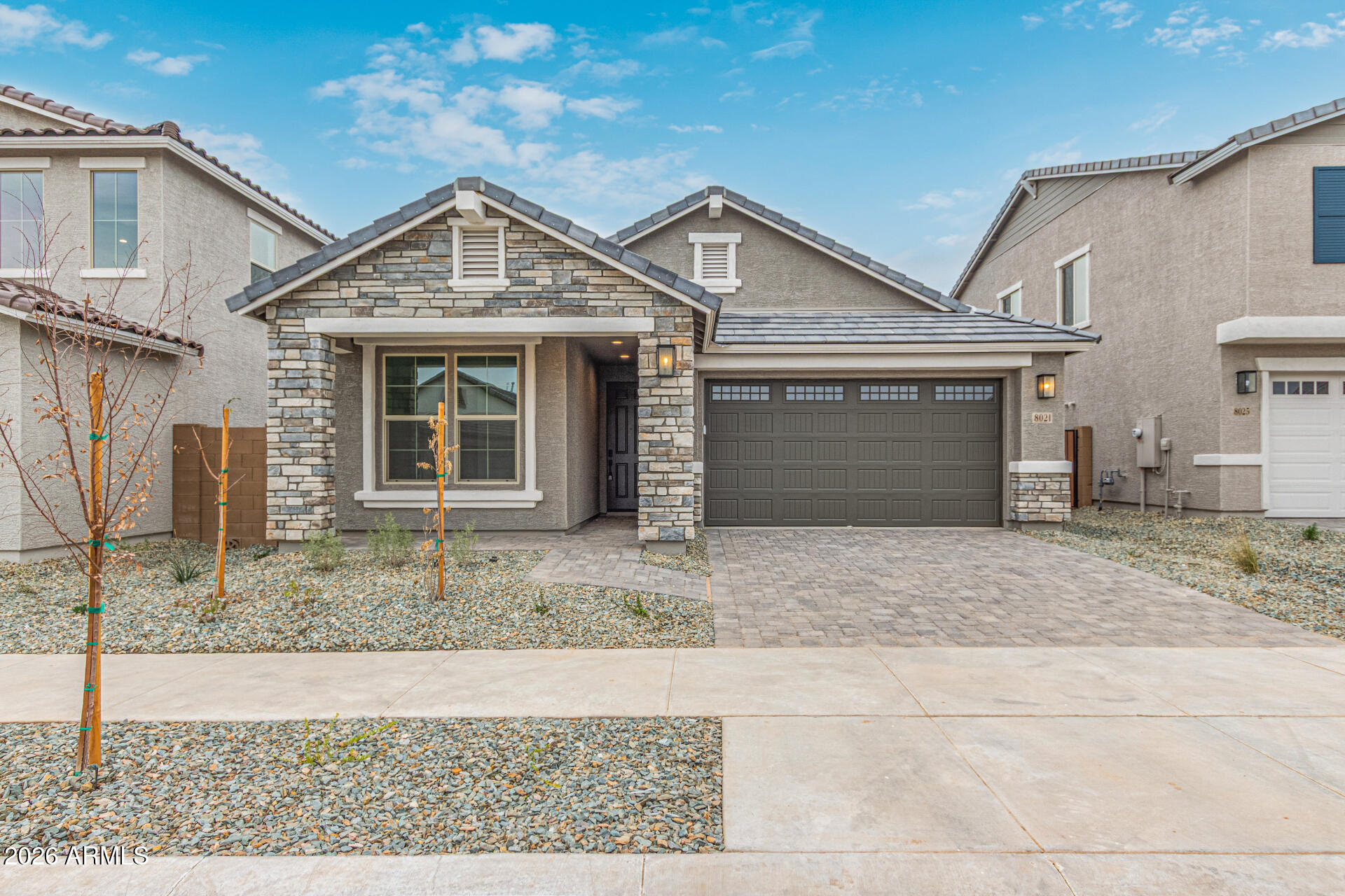 a front view of a house with a yard and garage
