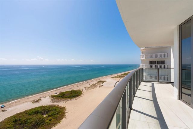 a living room with furniture a rug and a large window