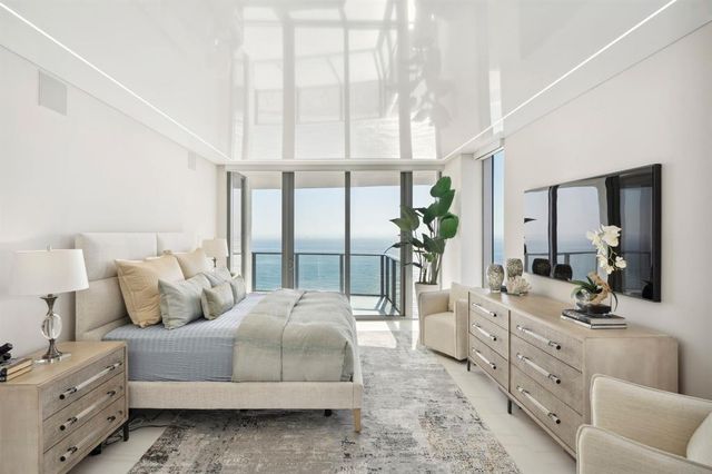 a view of living room with furniture and potted plant