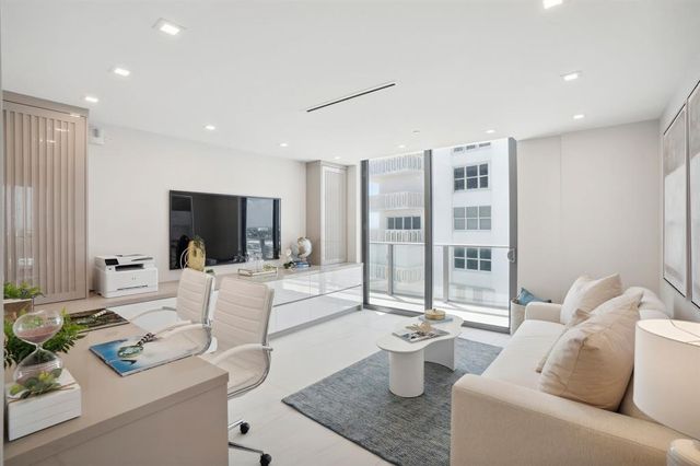 a bedroom with a large bed and a balcony view