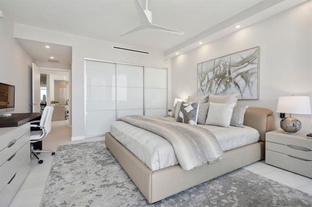 a front view of a building with a garden