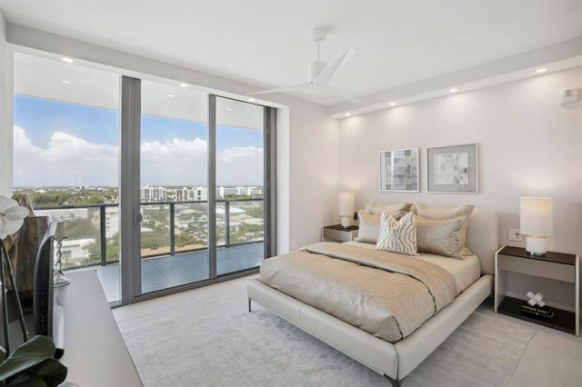 a view of lobby with two chair and a potted plant