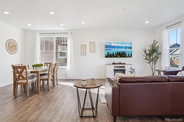 a view of a dining room with furniture window and wooden floor