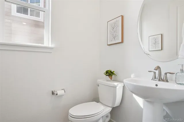 a bathroom with a sink mirror and toilet