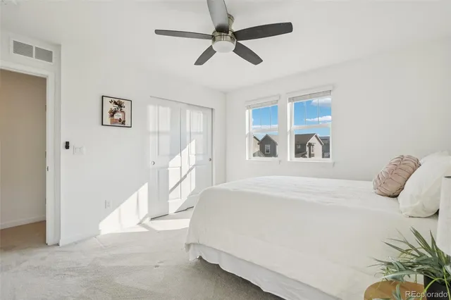 a bedroom with a bed and ceiling fan