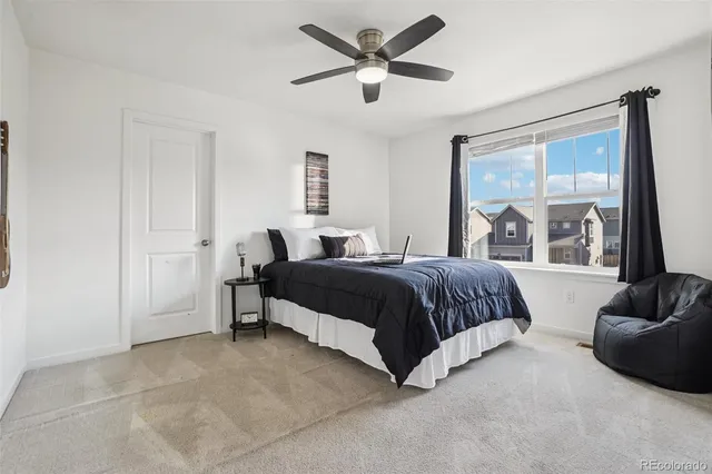 a bedroom with a bed and glass window