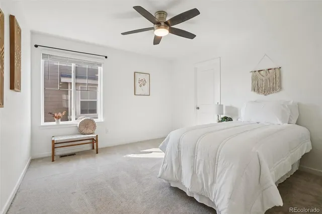 a spacious bedroom with a bed and a large window