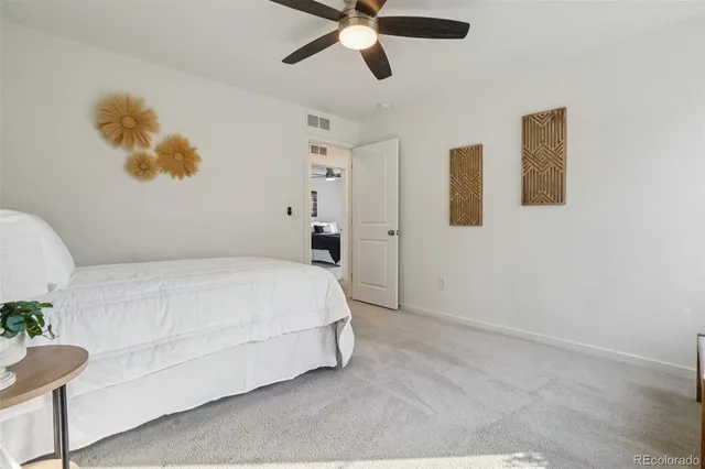 a bedroom with a bed and a painting on the wall