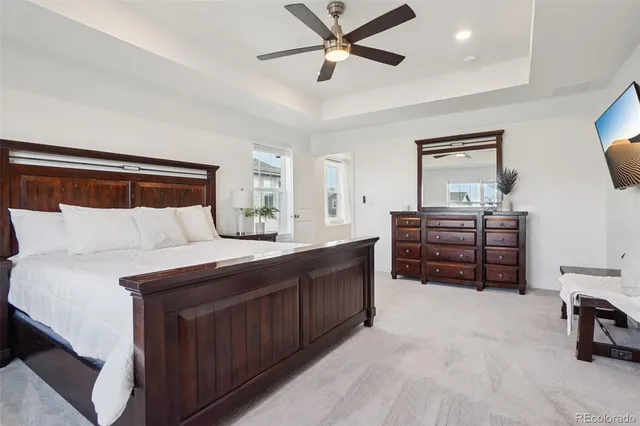a spacious bedroom with a bed and a chandelier
