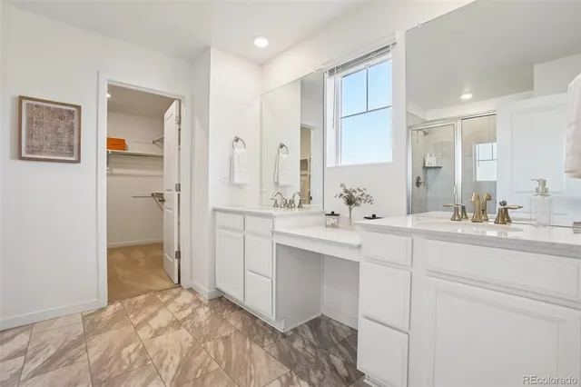 a spacious bathroom with a sink shower and a mirror
