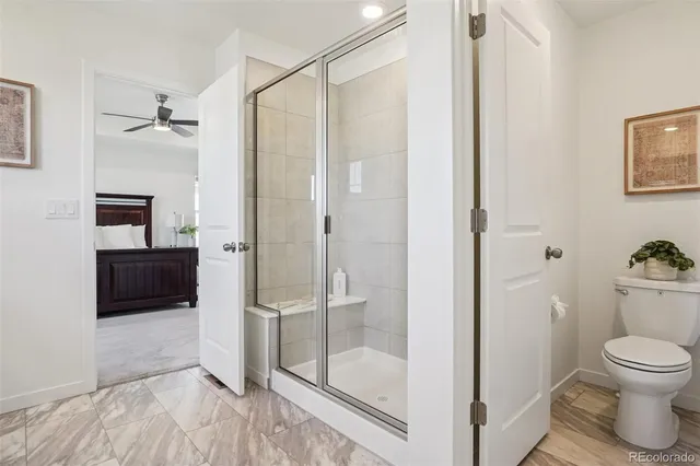 a bathroom with a shower and a toilet