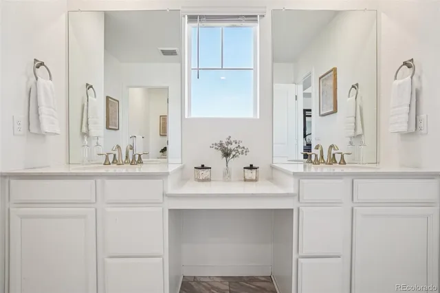 a bathroom with a sink vanity and a mirror