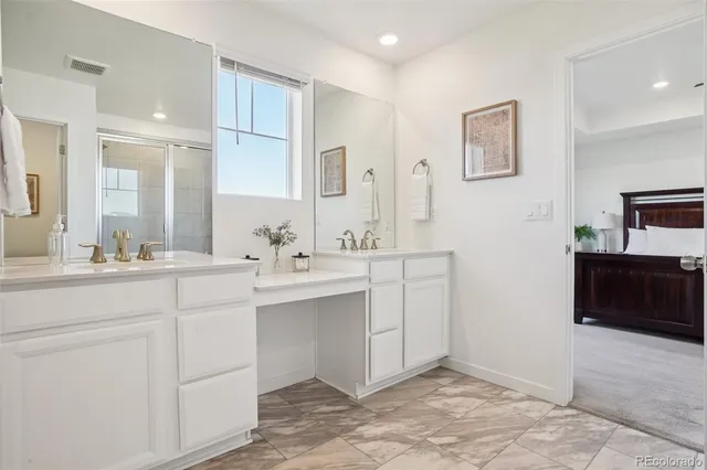 a bathroom with a sink double vanity and a mirror