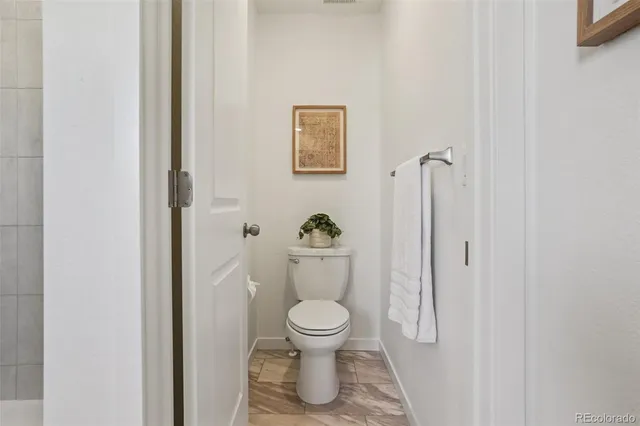 a white toilet sitting next to a bathroom sink