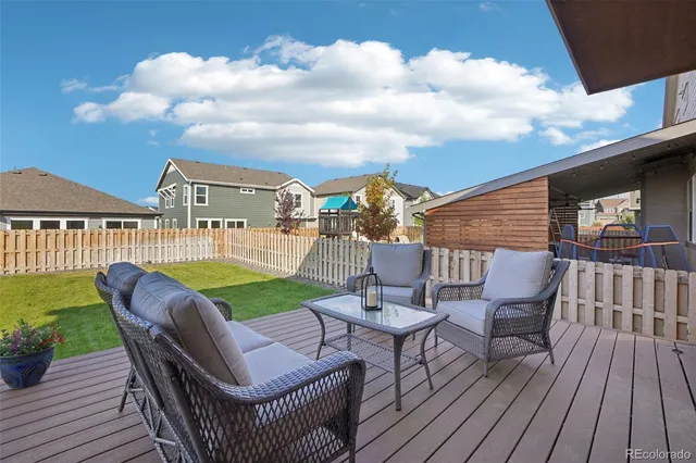 a view of a roof deck with furniture