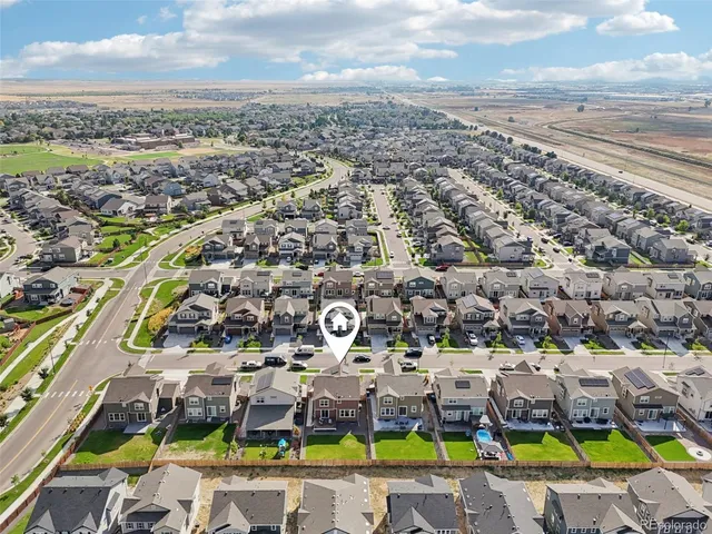 an aerial view of a city with lots of residential buildings ocean and mountain view in back