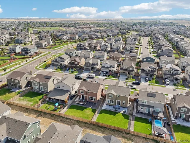 an aerial view of a house with a garden and lake view
