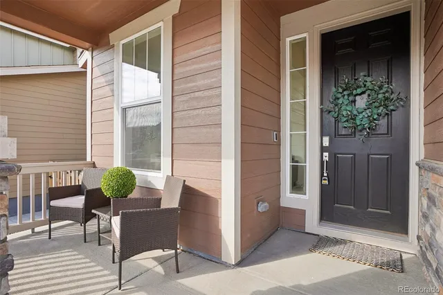 a view of a balcony with chairs and a potted plant
