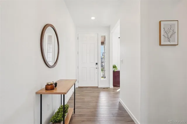 a view of a room with wooden floor and a potted plant