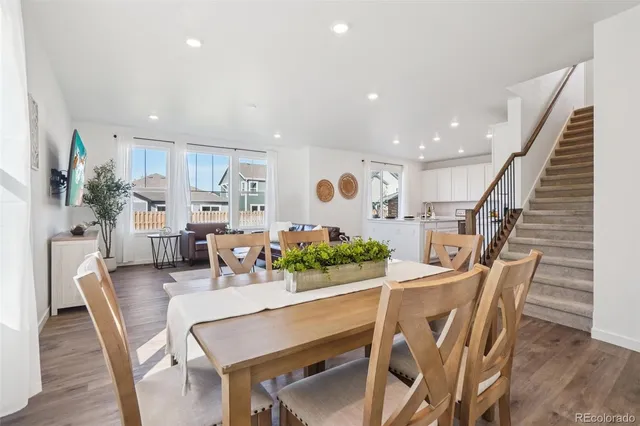 a dining room with furniture and wooden floor