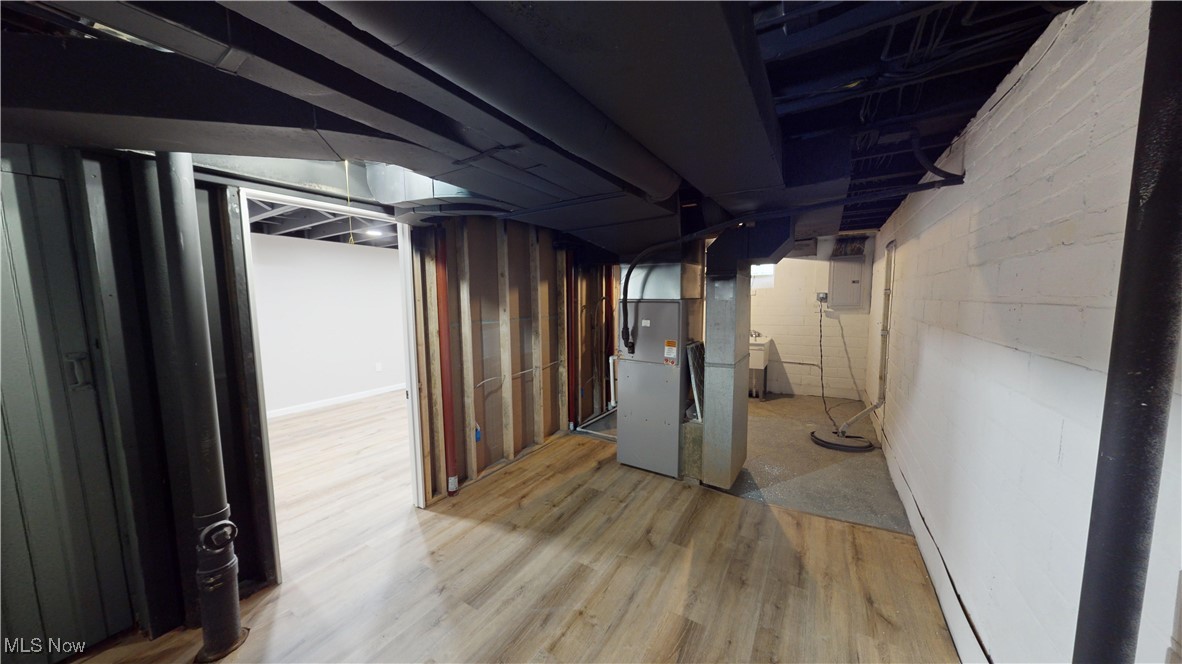 5252 Spencer Road Cleveland, OH 44124 - Photo 27 of 33 Basement with heating unit and light wood-type flooring