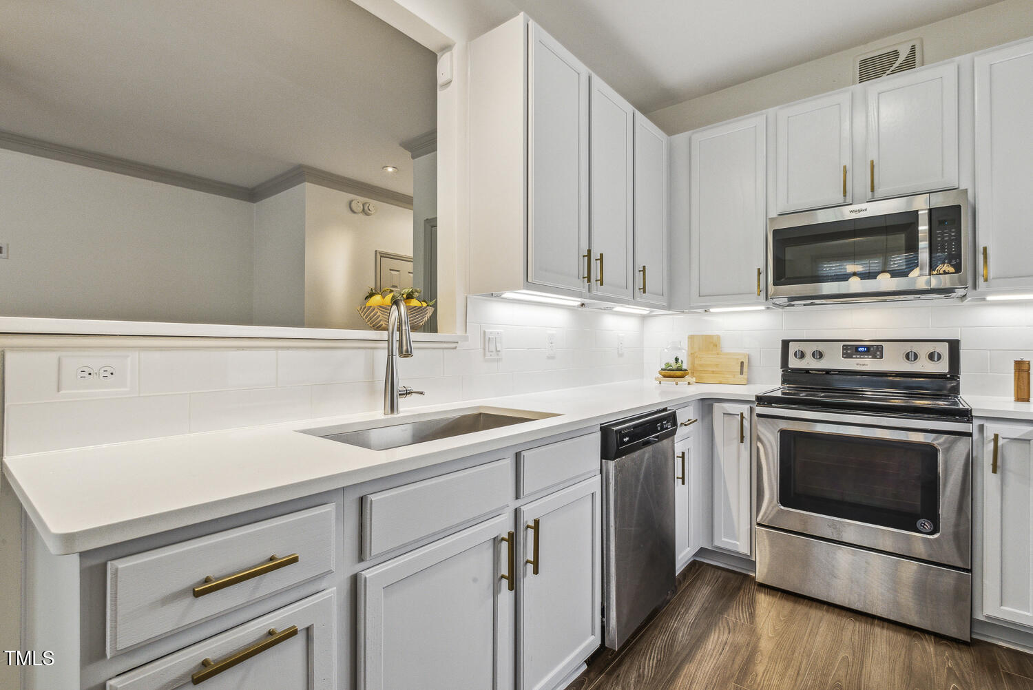5402 Goldenglow Way Raleigh, NC 27606 - Photo 16 of 44 a kitchen with white cabinets stainless steel appliances and sink