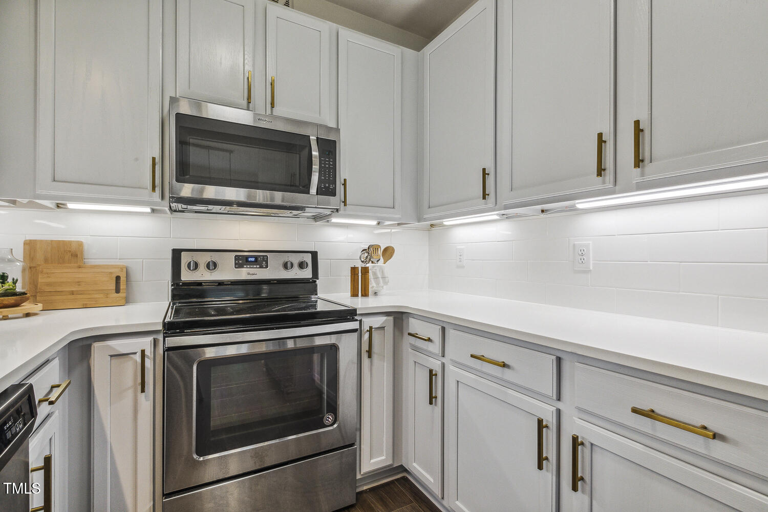 5402 Goldenglow Way Raleigh, NC 27606 - Photo 17 of 44 a kitchen with white cabinets stainless steel appliances and sink