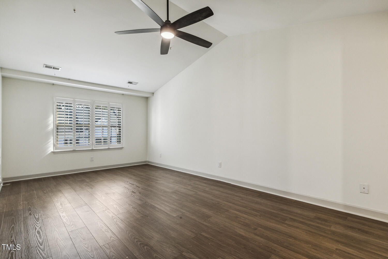 5402 Goldenglow Way Raleigh, NC 27606 - Photo 21 of 44 an empty room with wooden floor fan and windows