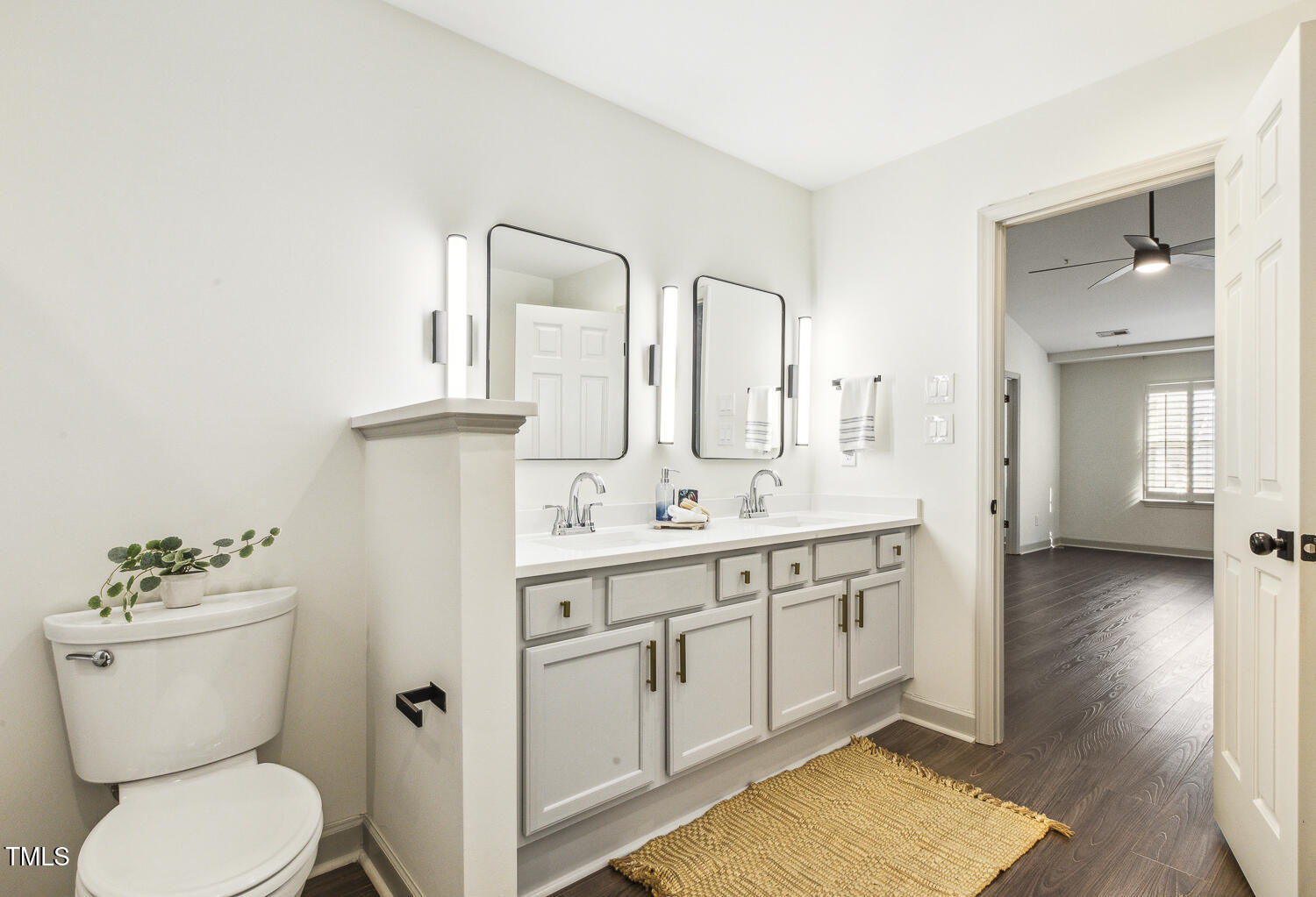 5402 Goldenglow Way Raleigh, NC 27606 - Photo 28 of 44 a bathroom with a toilet sink and mirror