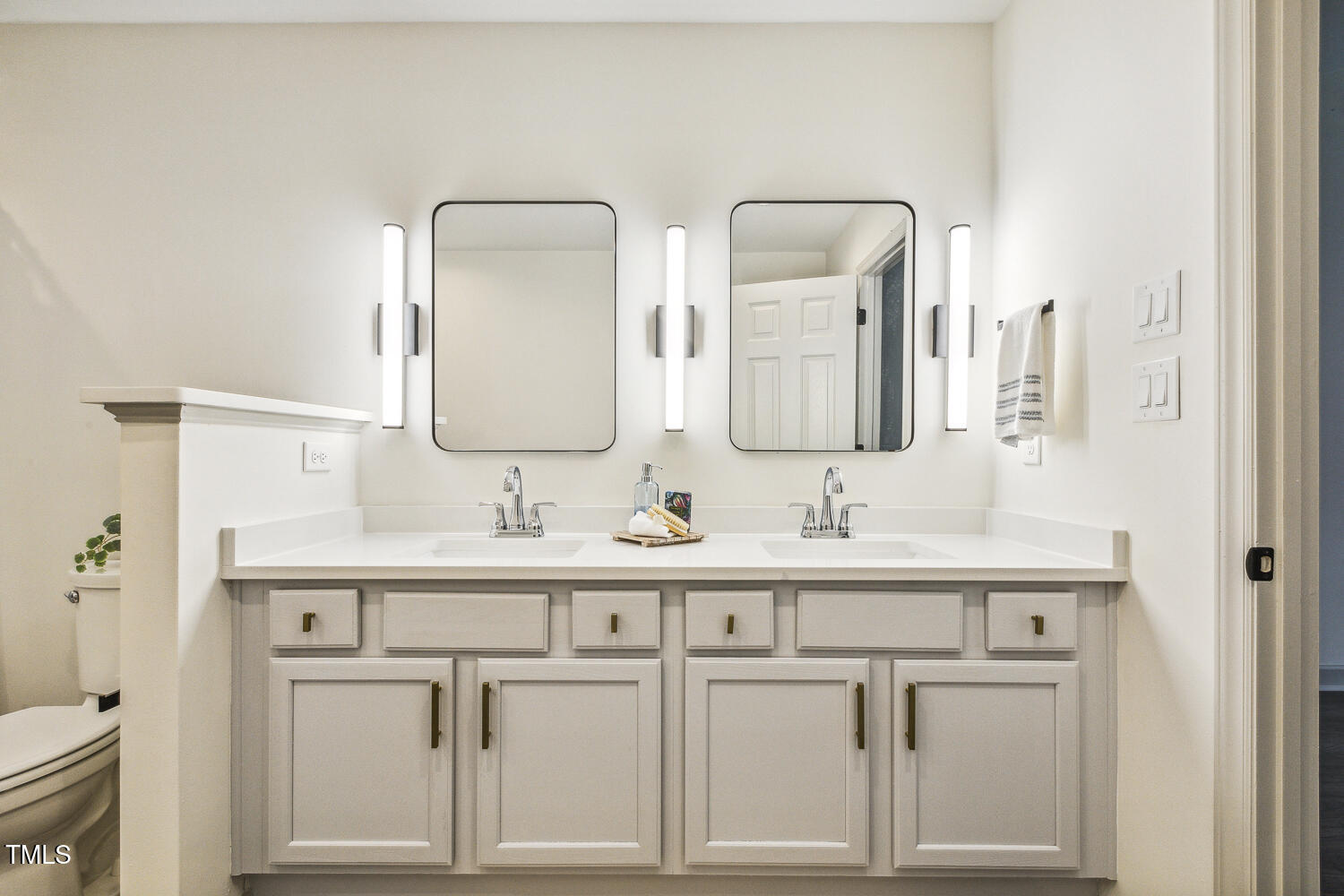 5402 Goldenglow Way Raleigh, NC 27606 - Photo 29 of 44 a bathroom with double vanity sinks and a mirror