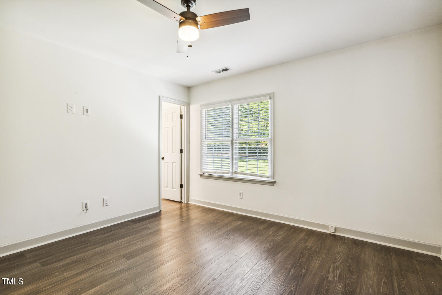 5402 Goldenglow Way Raleigh, NC 27606 - Photo 30 of 44 an empty room with wooden floor and windows