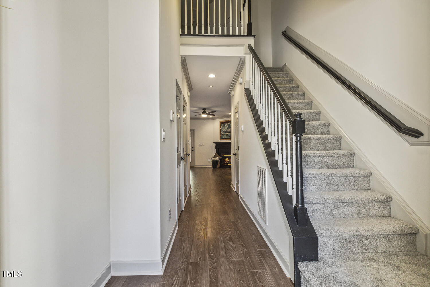 5402 Goldenglow Way Raleigh, NC 27606 - Photo 4 of 44 a view of a hallway with wooden floor and staircase