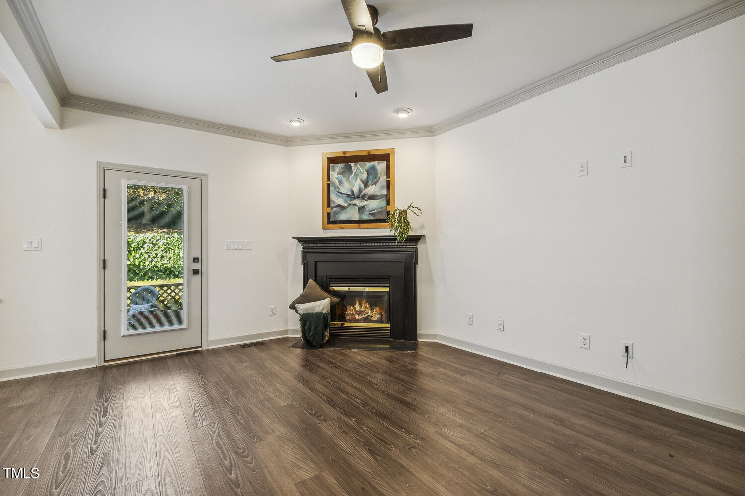 5402 Goldenglow Way Raleigh, NC 27606 - Photo 8 of 44 an empty room with windows a fireplace and wooden floor