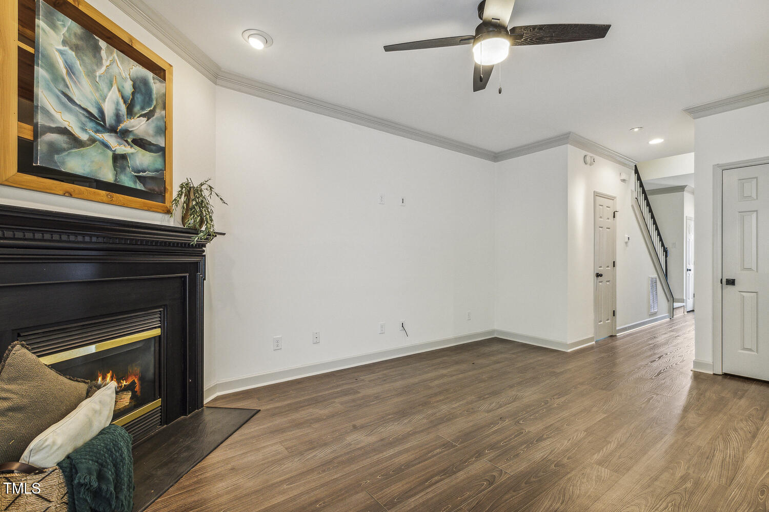 5402 Goldenglow Way Raleigh, NC 27606 - Photo 9 of 44 a view of an empty room with wooden floor a fireplace and a window