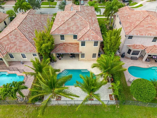 an aerial view of a house with swimming pool and patio