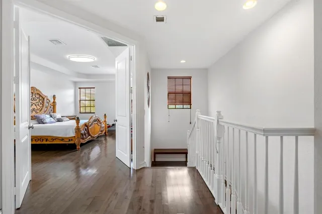 a bedroom with furniture and a wooden floor