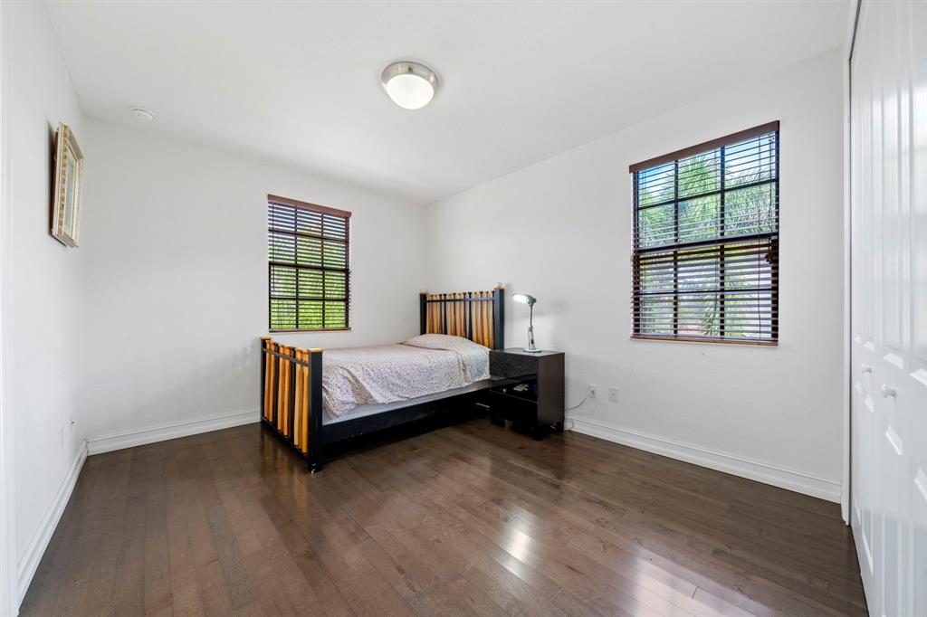 7302 Northwest 111th Way Parkland, FL 33076 - Photo 29 of 36 a bedroom with a bed and a window