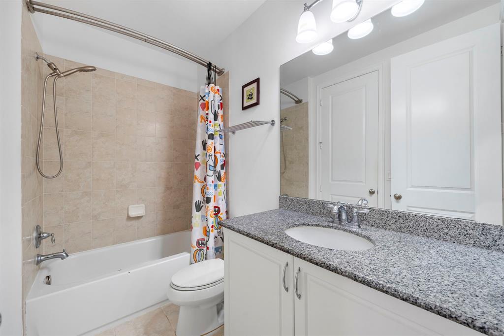 7302 Northwest 111th Way Parkland, FL 33076 - Photo 31 of 36 a bathroom with a granite countertop sink a toilet and shower