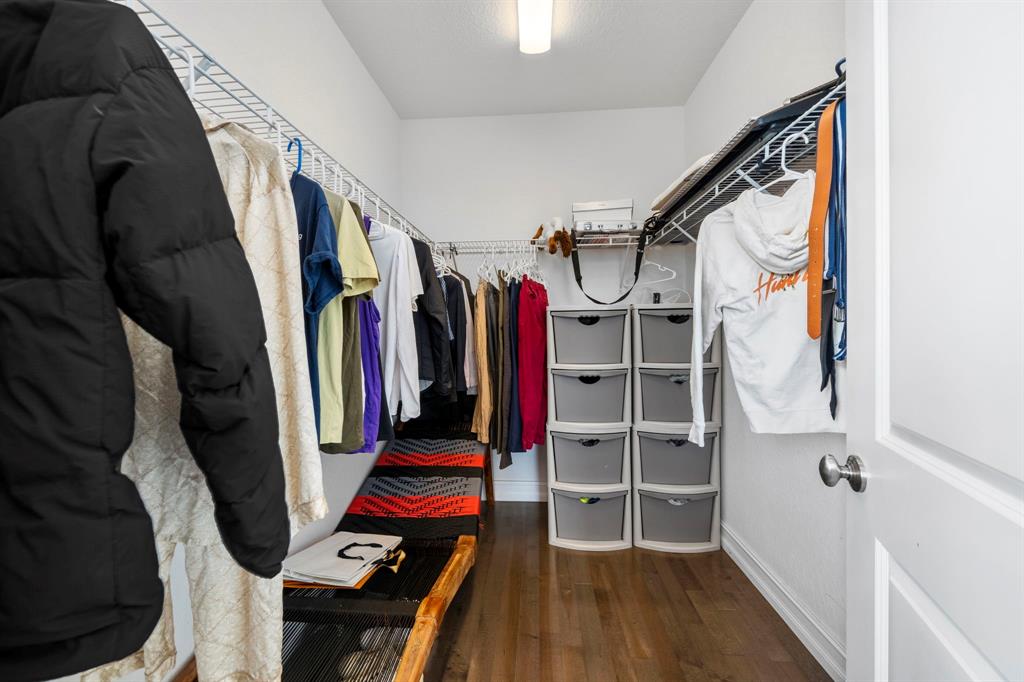 7302 Northwest 111th Way Parkland, FL 33076 - Photo 32 of 36 a view of walk in closet with clothes and shoes